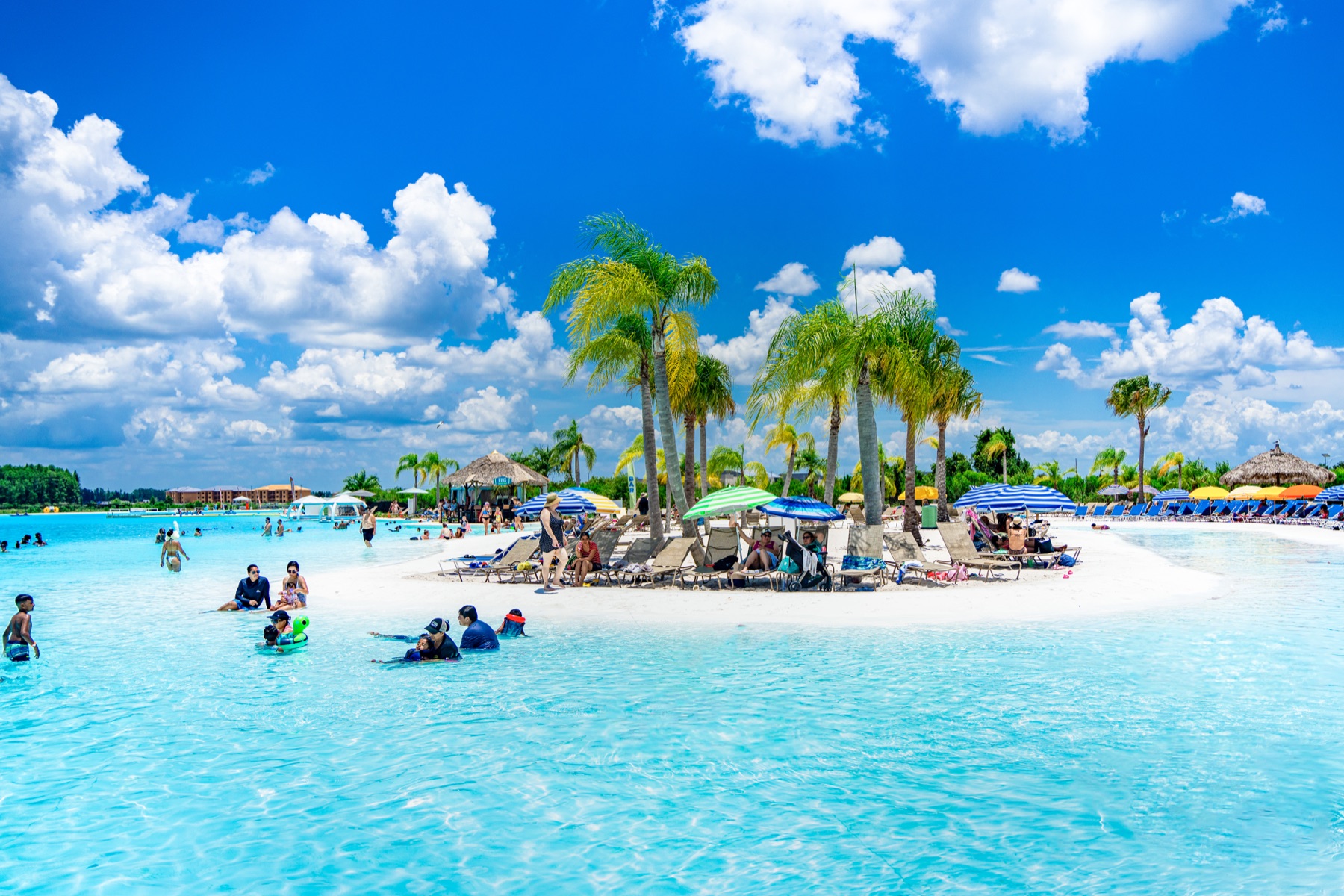 Families enjoying the turquoise water and white-sand island at Epperson Lagoon in Wesley Chapel, Florida
