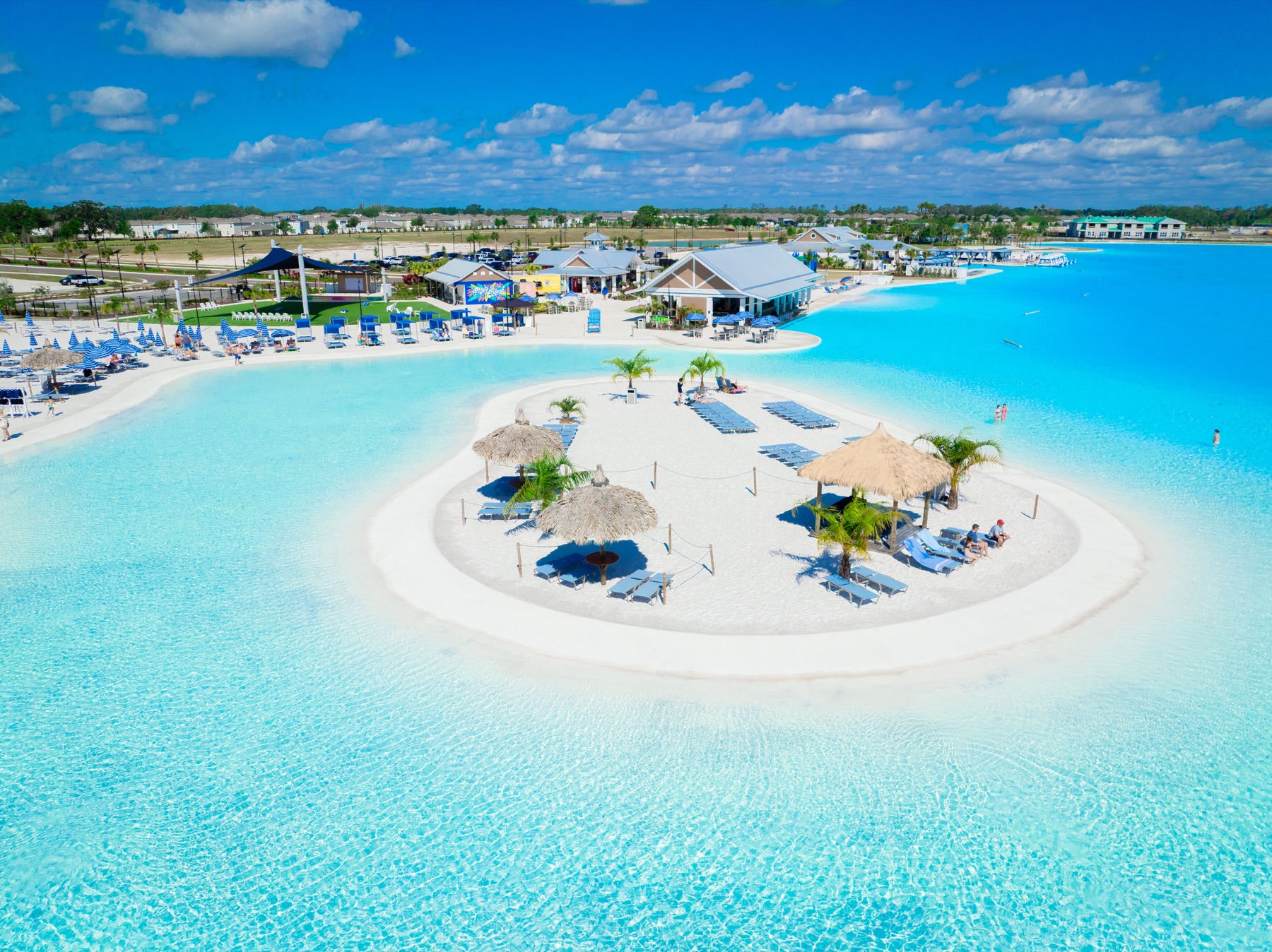 Aerial view of the turquoise Mirada Lagoon and white-sand island in San Antonio, Florida